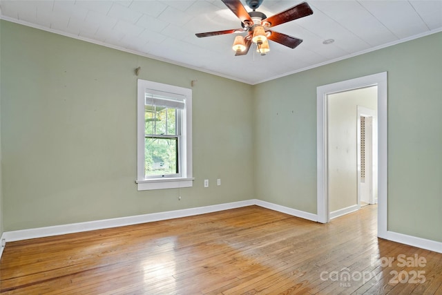 empty room with ornamental molding, light hardwood / wood-style floors, and ceiling fan