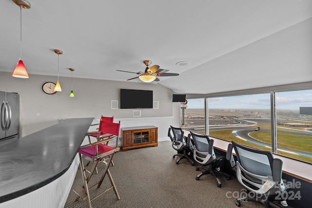 home office featuring carpet floors, vaulted ceiling, and ceiling fan