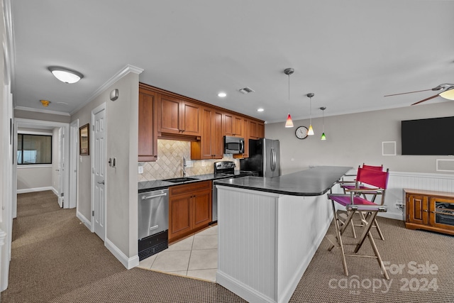 kitchen featuring visible vents, a sink, appliances with stainless steel finishes, dark countertops, and light colored carpet