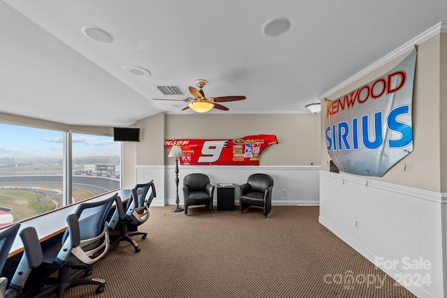 office space featuring visible vents, a ceiling fan, a wainscoted wall, and carpet floors