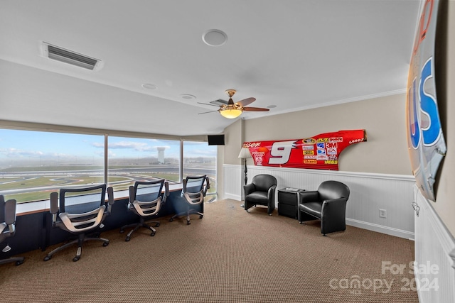 carpeted home office featuring crown molding, ceiling fan, and plenty of natural light