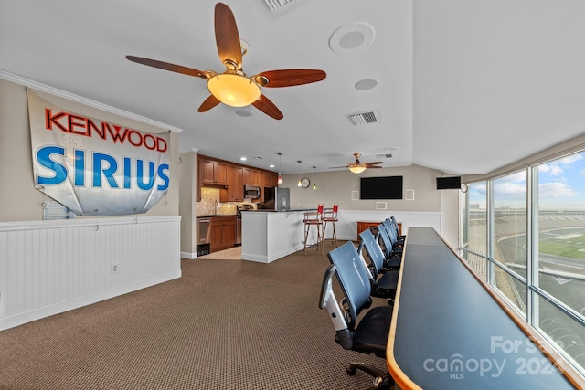 office space with vaulted ceiling, ceiling fan, and carpet floors