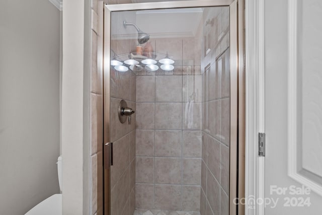 bathroom with walk in shower, crown molding, and toilet