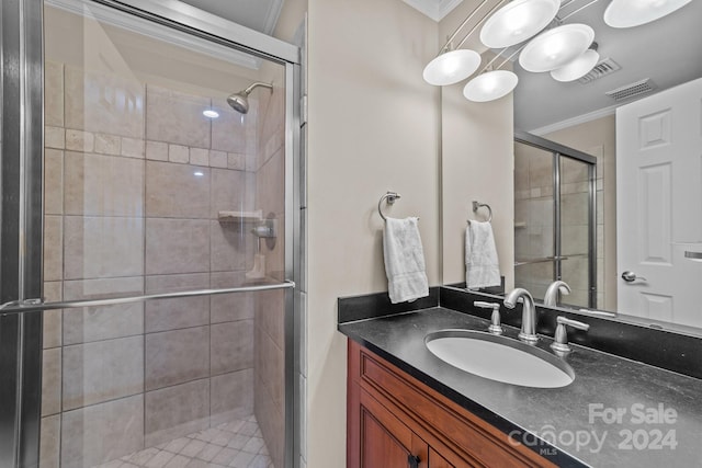 bathroom featuring vanity, crown molding, and a shower with door