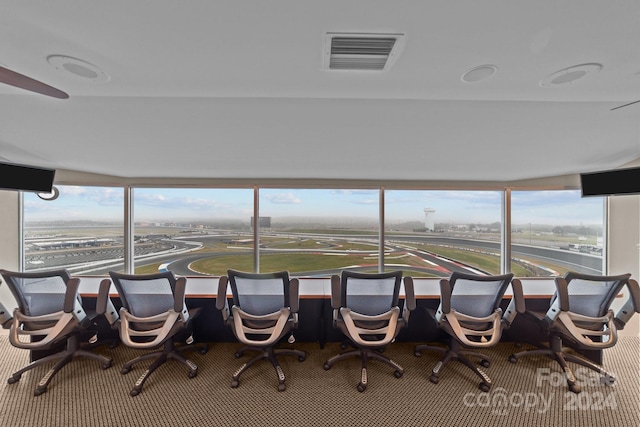interior space featuring a healthy amount of sunlight, visible vents, and carpet floors