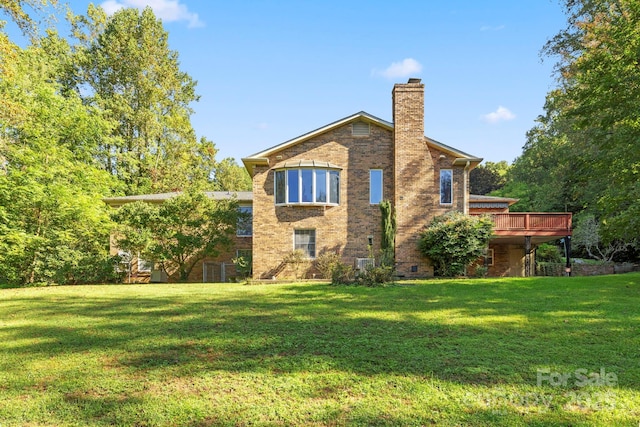 back of house with a lawn and a wooden deck