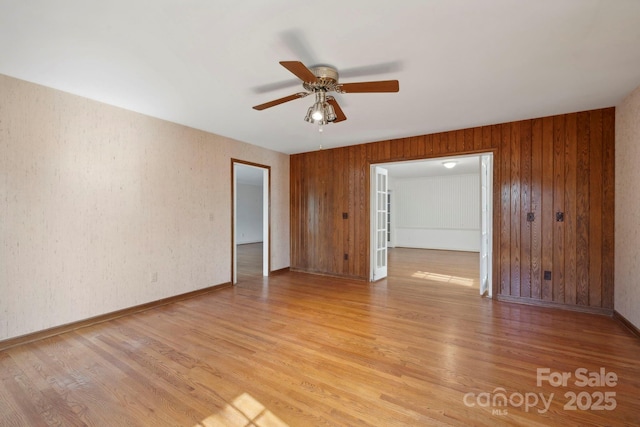 spare room featuring light hardwood / wood-style flooring and ceiling fan