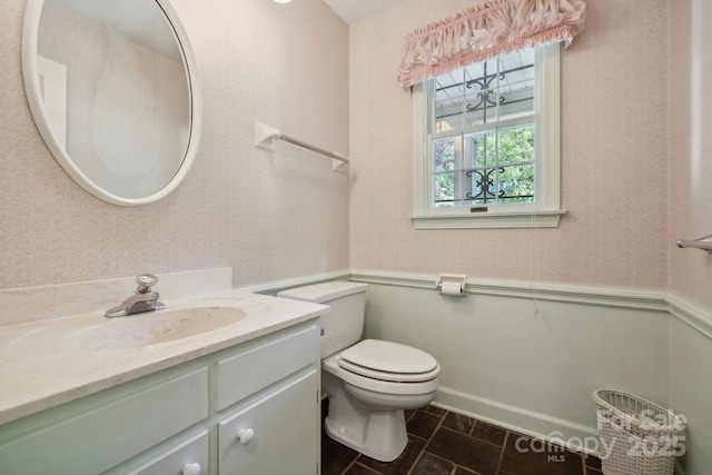 bathroom featuring tile patterned floors, vanity, and toilet