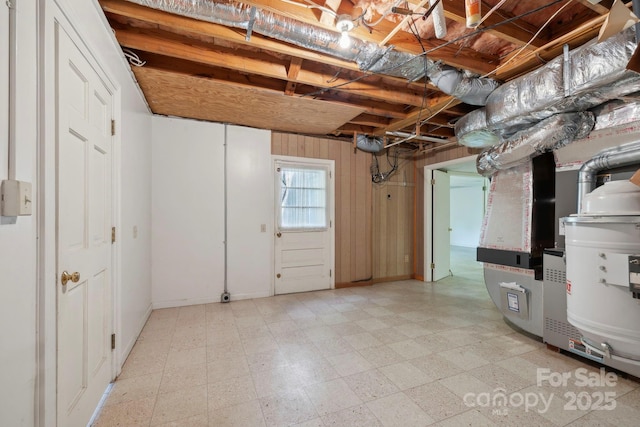 basement featuring wood walls