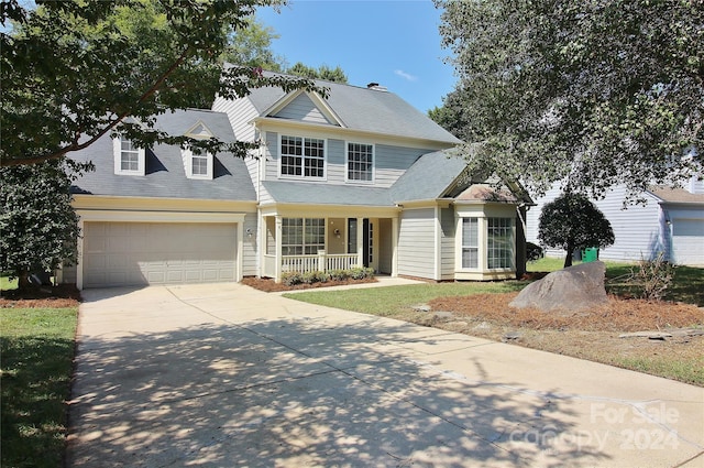 view of front property featuring a garage and covered porch