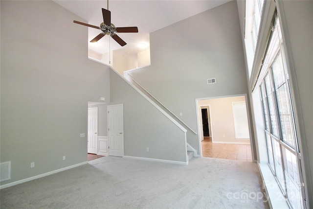 unfurnished living room featuring ceiling fan, light carpet, and high vaulted ceiling