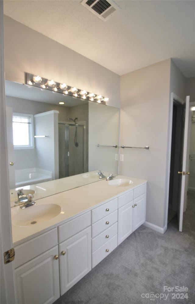 bathroom featuring plus walk in shower and vanity