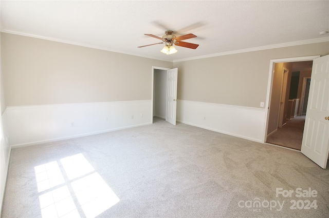 unfurnished room with ceiling fan, ornamental molding, and light carpet