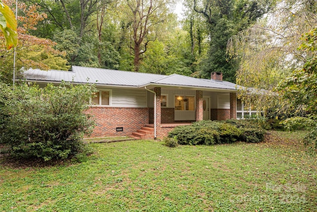 ranch-style house with a front yard and a porch