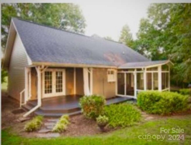 back of house featuring a patio and a sunroom