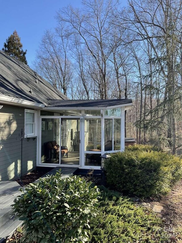 rear view of property with a sunroom