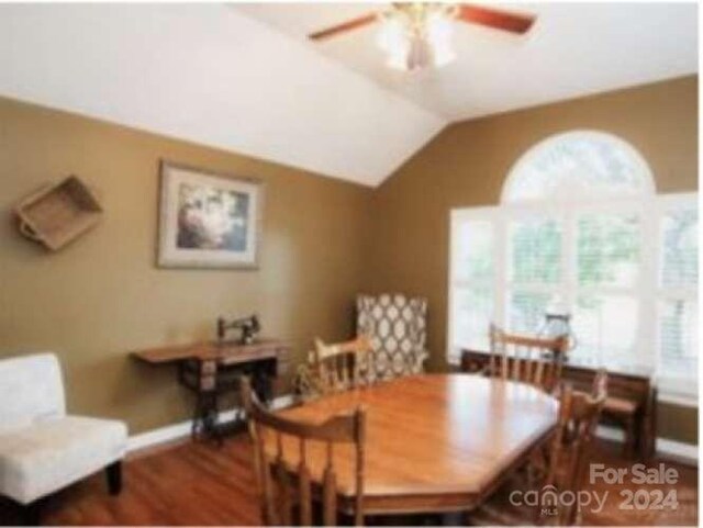 dining room featuring vaulted ceiling, dark hardwood / wood-style flooring, and ceiling fan