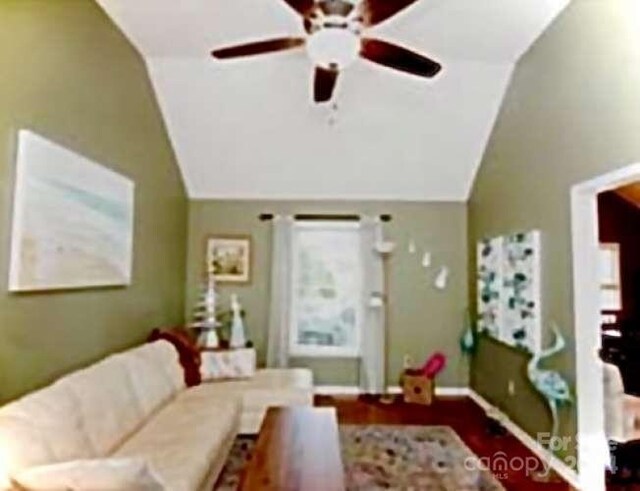 living room with ceiling fan and vaulted ceiling