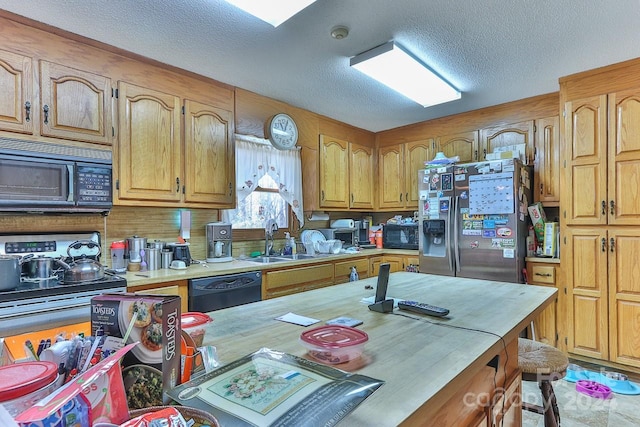 kitchen featuring black appliances, a textured ceiling, and sink