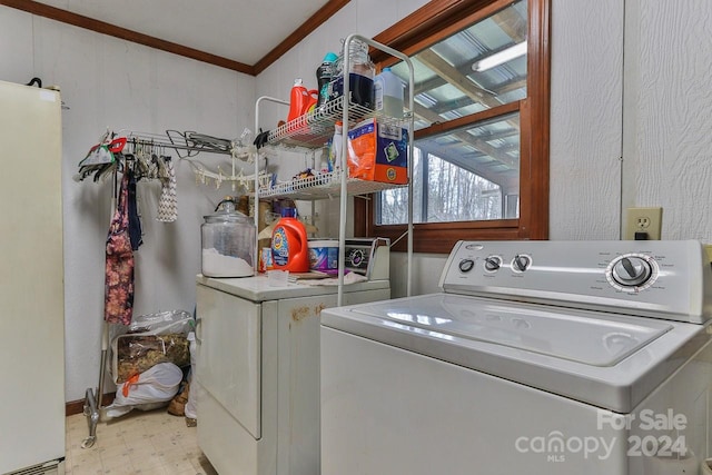 laundry area featuring ornamental molding and washing machine and dryer