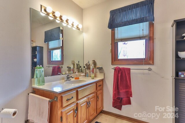 bathroom with tile patterned flooring and vanity