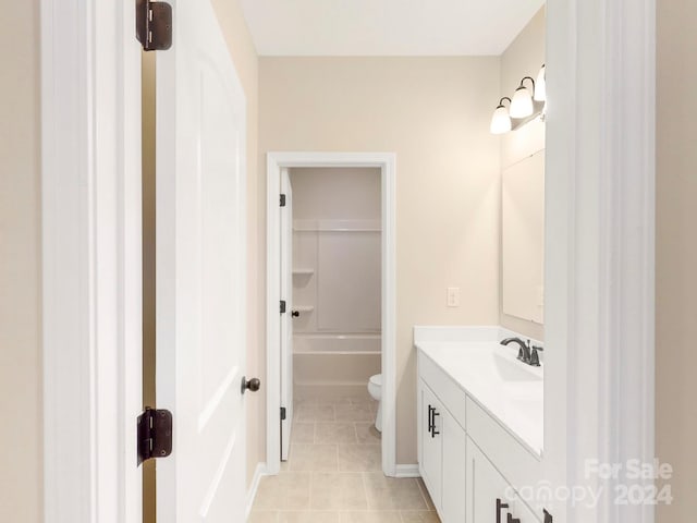 bathroom featuring vanity, toilet, and tile patterned flooring