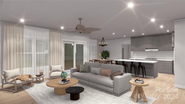 living room with ceiling fan, sink, and light hardwood / wood-style floors