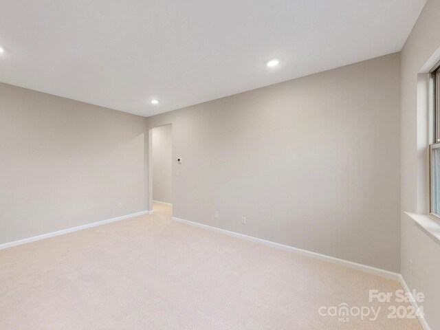 empty room with light colored carpet