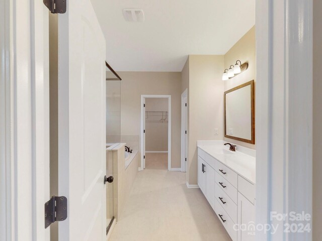 bathroom featuring vanity and shower with separate bathtub