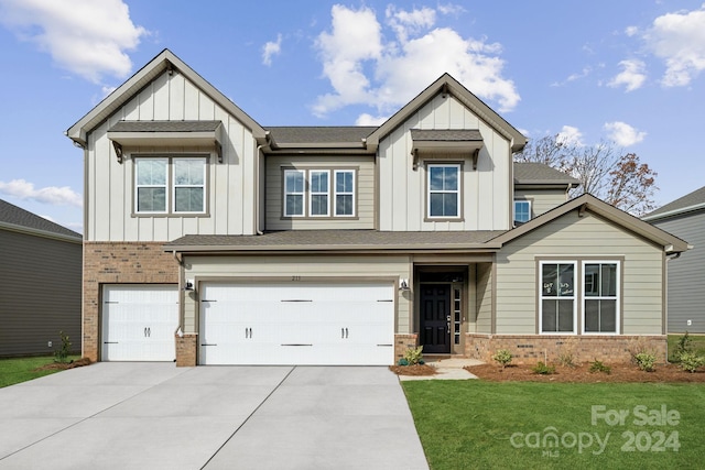 craftsman-style house featuring a garage and a front lawn