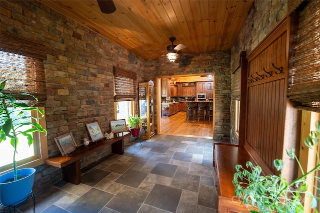 hallway featuring wood ceiling, a wealth of natural light, and dark hardwood / wood-style floors