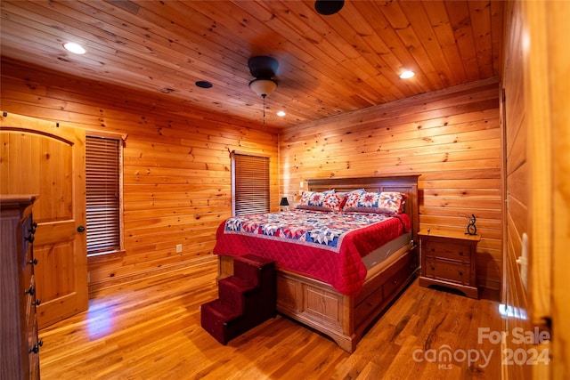 bedroom featuring wood ceiling, wood-type flooring, and wood walls