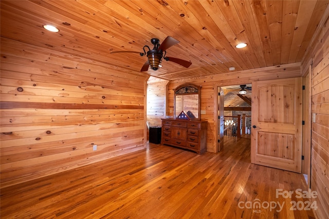 interior space with wood walls, hardwood / wood-style floors, and wooden ceiling