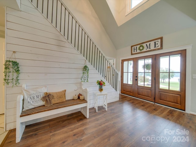entryway with french doors, stairway, high vaulted ceiling, and hardwood / wood-style flooring