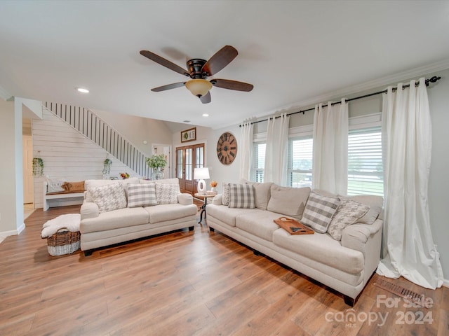 living room featuring light wood-type flooring and ceiling fan