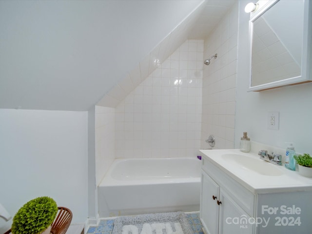 bathroom featuring vanity, tiled shower / bath combo, and tile patterned floors