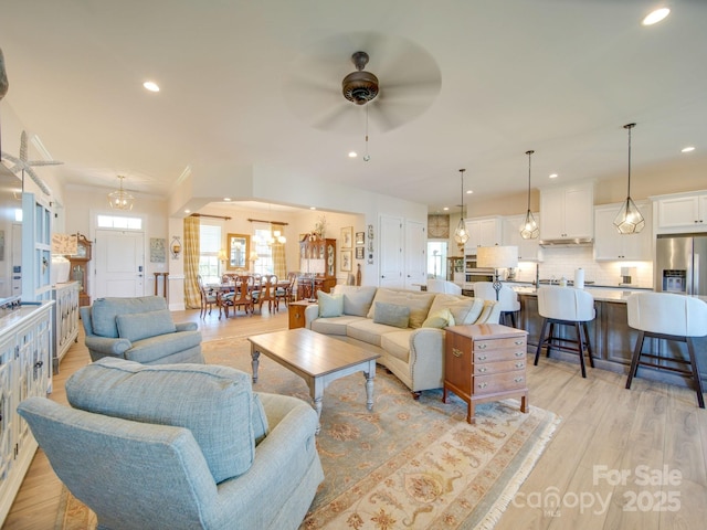 living room featuring light hardwood / wood-style flooring and ceiling fan