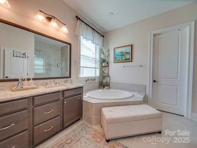 bathroom featuring vanity, independent shower and bath, and tile patterned flooring