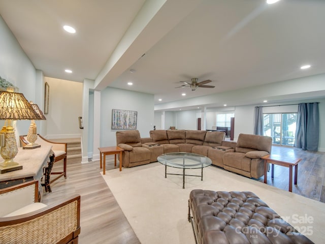 living room featuring ceiling fan and light hardwood / wood-style flooring