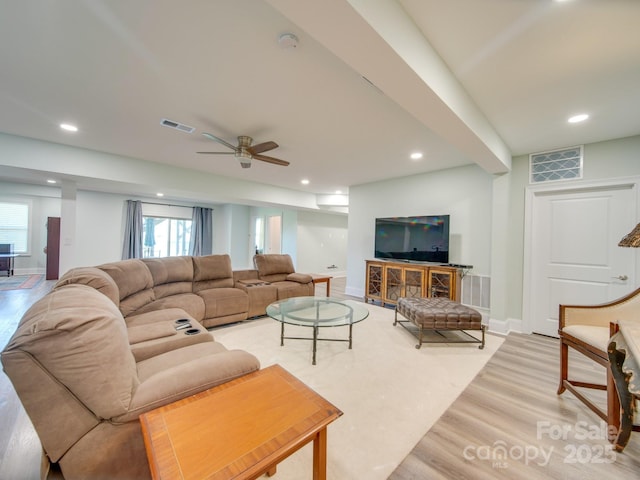 living room with ceiling fan and light hardwood / wood-style flooring