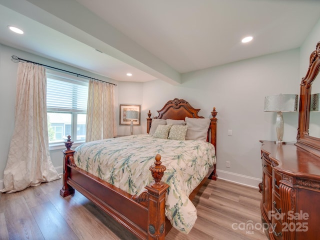 bedroom featuring beamed ceiling and hardwood / wood-style floors