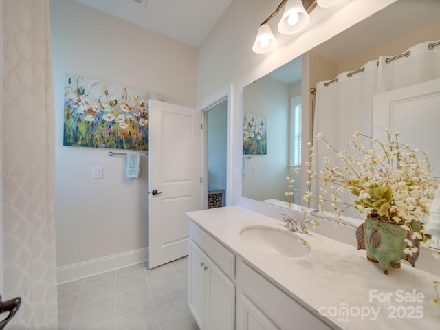 bathroom with tile patterned floors and vanity