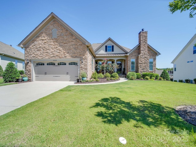 view of front of property featuring a garage and a front lawn