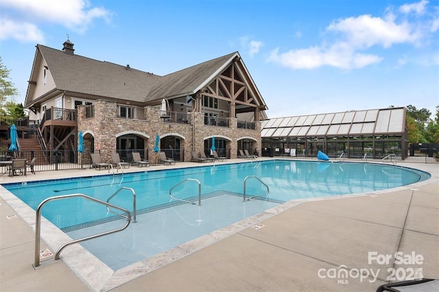 view of swimming pool with a patio