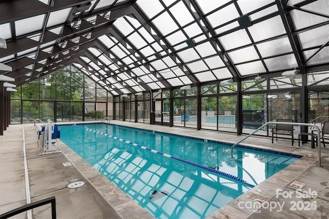 view of swimming pool featuring a lanai