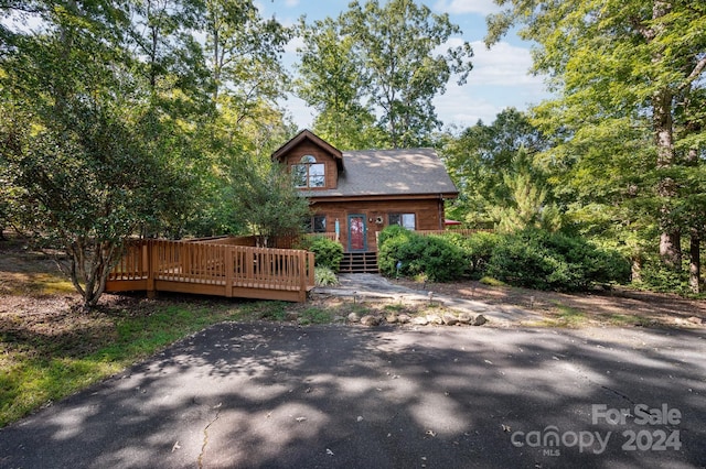 view of front facade with a wooden deck