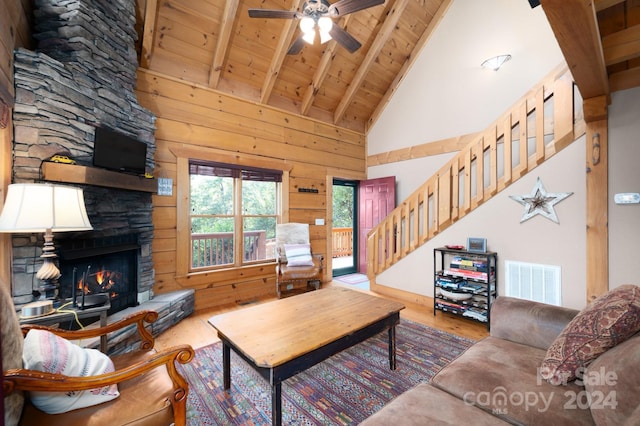 117 Laurel Lakes Pkwy, Lake Lure, NC 28746 - living room featuring wood finished floors, wooden ceiling, high vaulted ceiling, stairway, and a stone fireplace