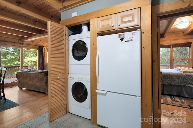 117 Laurel Lakes Pkwy, Lake Lure, NC 28746 - laundry area featuring stacked washer / dryer, wood ceiling, and light tile patterned flooring
