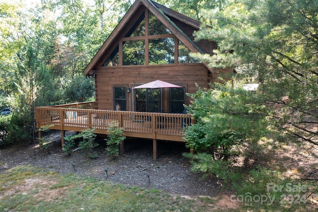 rear view of property featuring a deck