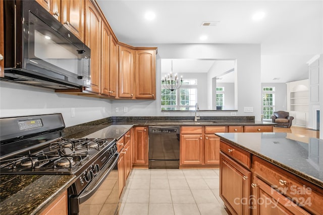 kitchen with dark stone counters, a chandelier, black appliances, a sink, and visible vents